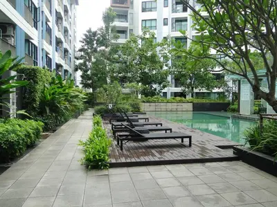 a row of benches in a courtyard in a building at Apartment near Central phuket in Phuket Town