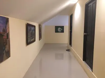 an empty hallway with paintings on the walls at Blueskyhouse Patong in Patong Beach