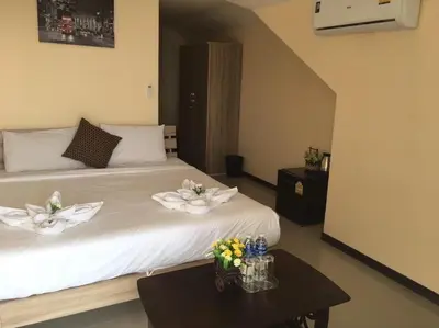 a bedroom with a white bed with flowers on it at Blueskyhouse Patong in Patong Beach
