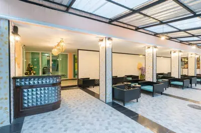 a lobby of a hotel with tables and chairs at Blueskyhouse Patong in Patong Beach