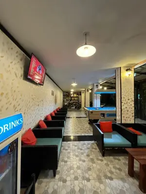 a room with couches and a pool table at Blueskyhouse Patong in Patong Beach