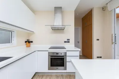 a kitchen with white counters and a stove top oven at Villa Maya 2BR private pool villa Nai Harn beach in Rawai Beach