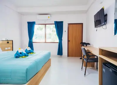a bedroom with a bed with two stuffed animals on it at Touch Sea Boutique Hotel&Bistro in Karon Beach