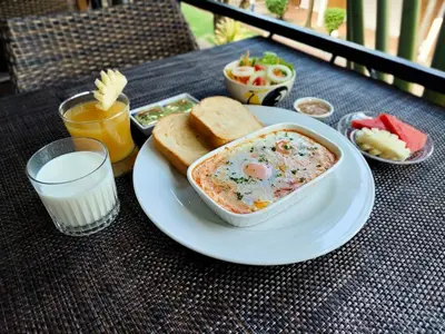 a plate of food with a bowl of dip and bread at Touch Sea Boutique Hotel&Bistro in Karon Beach