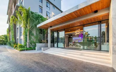 a facade of a building with large glass windows at Diamond Phuket Bang Tao in Bang Tao Beach