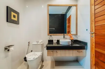 a bathroom with a sink and a toilet and a mirror at Zen Private Pool Villa Little Paradise in Rawai Beach