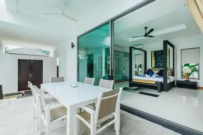 a dining room with a white table and chairs at Zen Private Pool Villa Little Paradise in Rawai Beach