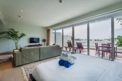 a bedroom with a bed and a living room at Daisy 2 Bedroom Amazing Seaview in Rawai Beach