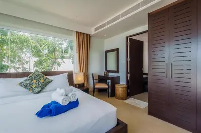 a bedroom with a bed with towels on it at Daisy 2 Bedroom Amazing Seaview in Rawai Beach