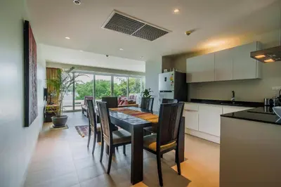 a kitchen and dining room with a table and chairs at Daisy 2 Bedroom Amazing Seaview in Rawai Beach