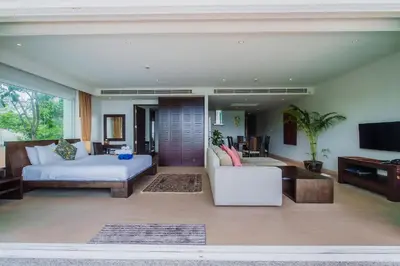 a living room with a bed and a couch at Daisy 2 Bedroom Amazing Seaview in Rawai Beach