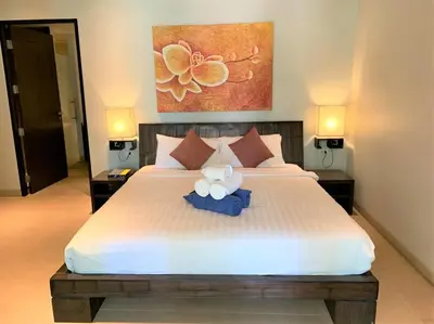 a bedroom with a large bed with two towels on it at Olive 1 Bedroom Beachfront in Rawai Beach