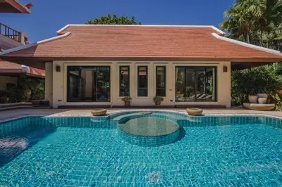 a swimming pool in front of a house at Solas Pool Villa Grand Villa With Private Pool in Rawai Beach