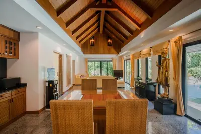 a dining room with a wooden table and chairs at Solas Pool Villa Grand Villa With Private Pool in Rawai Beach