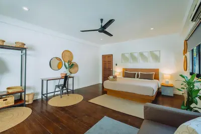 a bedroom with a bed and a ceiling fan at Eden Villa A Tropical Paradise Pool Villa in Rawai Beach