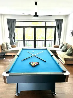 a pool table in the middle of a living room at Eden Villa A Tropical Paradise Pool Villa in Rawai Beach