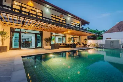 a swimming pool in the backyard of a house at Eden Villa A Tropical Paradise Pool Villa in Rawai Beach