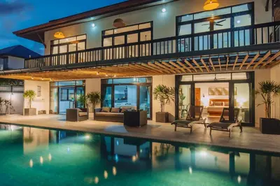 a house with a swimming pool in front of it at Eden Villa A Tropical Paradise Pool Villa in Rawai Beach