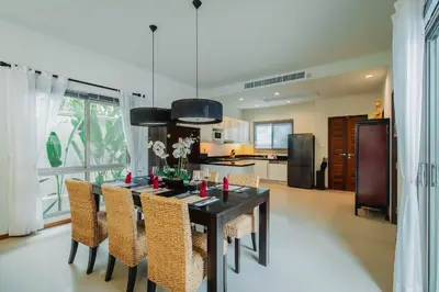 a kitchen with a dining room table and chairs at Ivory Pool Villa Dreamy Villa With Sparkling Pool in Rawai Beach