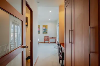 a hallway with a door open to a dining room at Ivory Pool Villa Dreamy Villa With Sparkling Pool in Rawai Beach