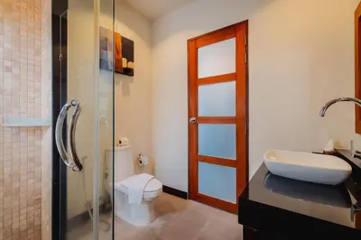 a bathroom with a toilet and a sink and a shower at Ivory Pool Villa Dreamy Villa With Sparkling Pool in Rawai Beach