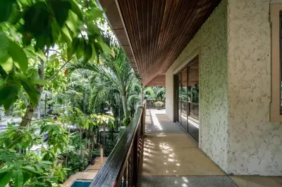 an external view of a house with trees and a balcony at Orchid Pool Villa Lavish Villa In Perfect Location in Rawai Beach