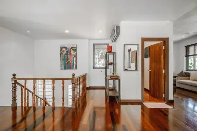 a living room with a staircase and white walls at Orchid Pool Villa Lavish Villa In Perfect Location in Rawai Beach