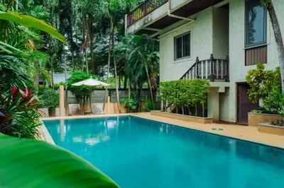 a swimming pool in front of a building at Orchid Pool Villa Lavish Villa In Perfect Location in Rawai Beach
