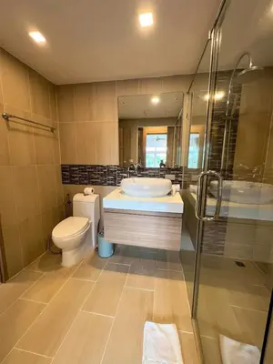 a bathroom with a sink and a toilet and a shower at Calypso Gardens 1 Bedroom Condo In Nai Harn in Rawai Beach