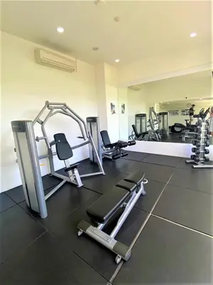a gym with several treadmills and machines at Maroon Studio at the beachfront in Rawai Beach
