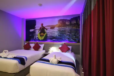 a room with two beds with a large painting on the wall at KRABI Residence in Ban Khlong Haeng