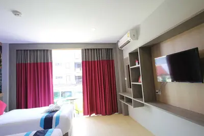 a hotel room with a bed and a large window at KRABI Residence in Ban Khlong Haeng