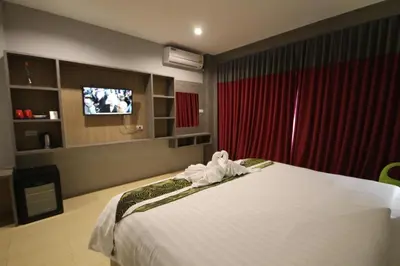 a hotel room with a bed and a tv at KRABI Residence in Ban Khlong Haeng