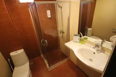 a bathroom with a shower and a toilet and a sink at KRABI Residence in Ban Khlong Haeng