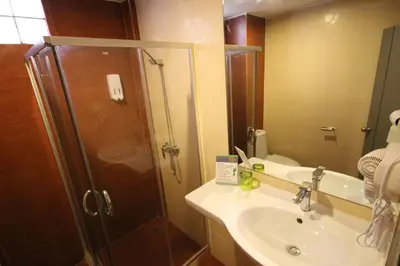 a bathroom with a shower and a sink at KRABI Residence in Ban Khlong Haeng