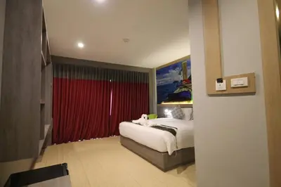 a bedroom with a bed and a red curtain at KRABI Residence in Ban Khlong Haeng