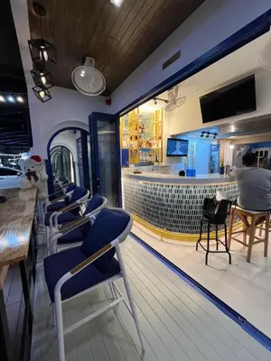 a bowling alley with blue chairs and a bar at Fantastic Karon Beach guest house in Karon Beach