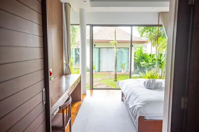 a bedroom with a bed and a large window at Phuket Boutique Pool Villa-80 in Rawai Beach