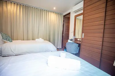 a hotel room with two beds and a window at Phuket Boutique Pool Villa-80 in Rawai Beach