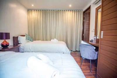 a hotel room with two beds and a desk at Phuket Boutique Pool Villa-80 in Rawai Beach