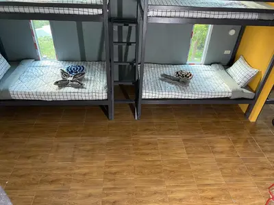 a room with two bunk beds and a wooden floor at The view Hostel in Phi Phi Don