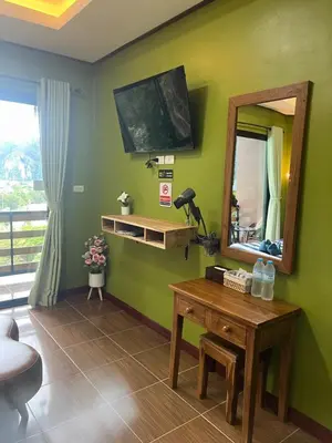 a room with a mirror and a table with at The view Hostel in Phi Phi Don
