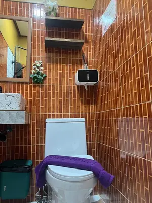 a bathroom with a toilet with a purple towel on it at The view Hostel in Phi Phi Don