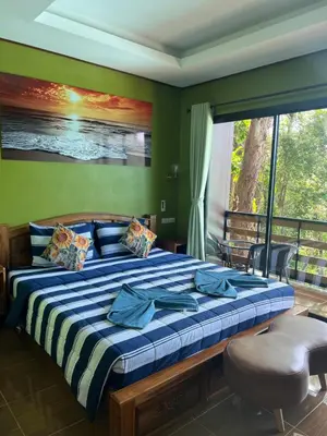 a bedroom with a large bed and a balcony at The view Hostel in Phi Phi Don