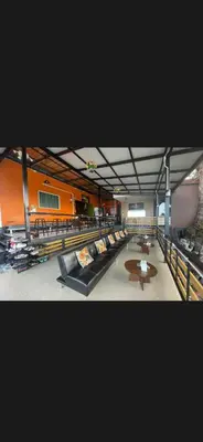 a large room with many couches and a table at The view Hostel in Phi Phi Don