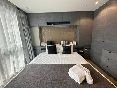a bedroom with a large bed with white sheets and pillows at Luxury one apartment for rent Kamala in Kathu
