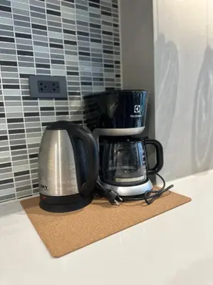 two coffeemakers sitting on a counter in a kitchen at Luxury one apartment for rent Kamala in Kathu
