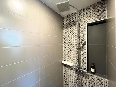 a shower with a glass door in a bathroom at Cozy studio Splendid Condo by Lofty in Kata Beach