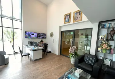 a man sitting at a desk in a living room at Cozy studio Splendid Condo by Lofty in Kata Beach