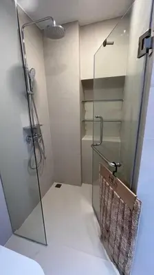 a bathroom with a shower with a glass door at Laguna Sky Park Corner 1 Bedroom in Bang Tao Beach
